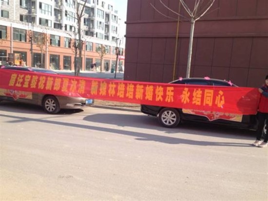 4s店,给新郎新娘摆个横幅祝他们百年好合,永结同心是必不可少的了